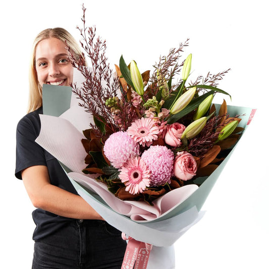 Gorgeous Pink Bouquet featuring pink lilies gerberas chrysanthemums and roses with native foliage wrapped for same-day flower delivery