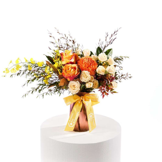 Golden Glow Vase with orange roses cream blooms yellow flowers and textured foliage for birthday flowers and same day delivery flowers