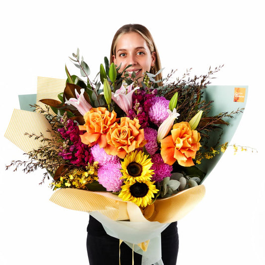 Spring Carnival Bouquet with vibrant orange roses pink chrysanthemums lilies and sunflowers for birthday flowers and same-day delivery flowers