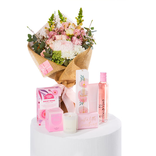 Pink & Pampered Hamper with a pink flower bouquet skincare treats and candle for birthday flowers and same-day delivery flowers